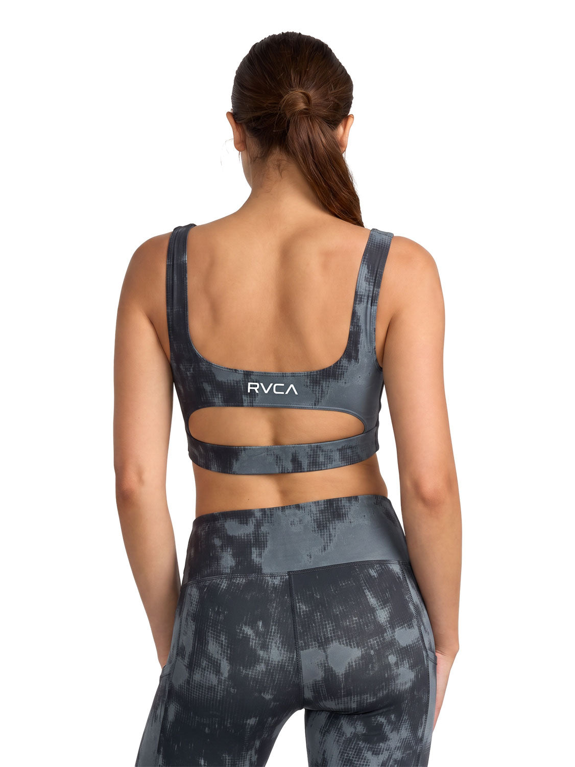 Dark gray and black tie-dye sports bra with a cutout. Featuring RVCA print. Back View