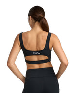 Black sports bra with a cutout. Featuring RVCA print. Back View
