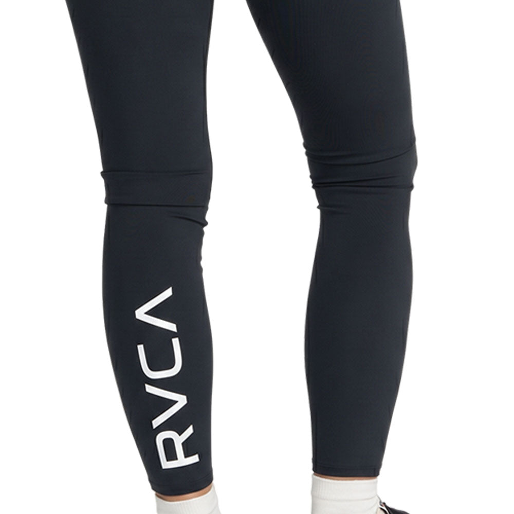 Black high-waisted athletic leggings with a large white vertical RVCA logo on the lower left leg. Back Close Up View