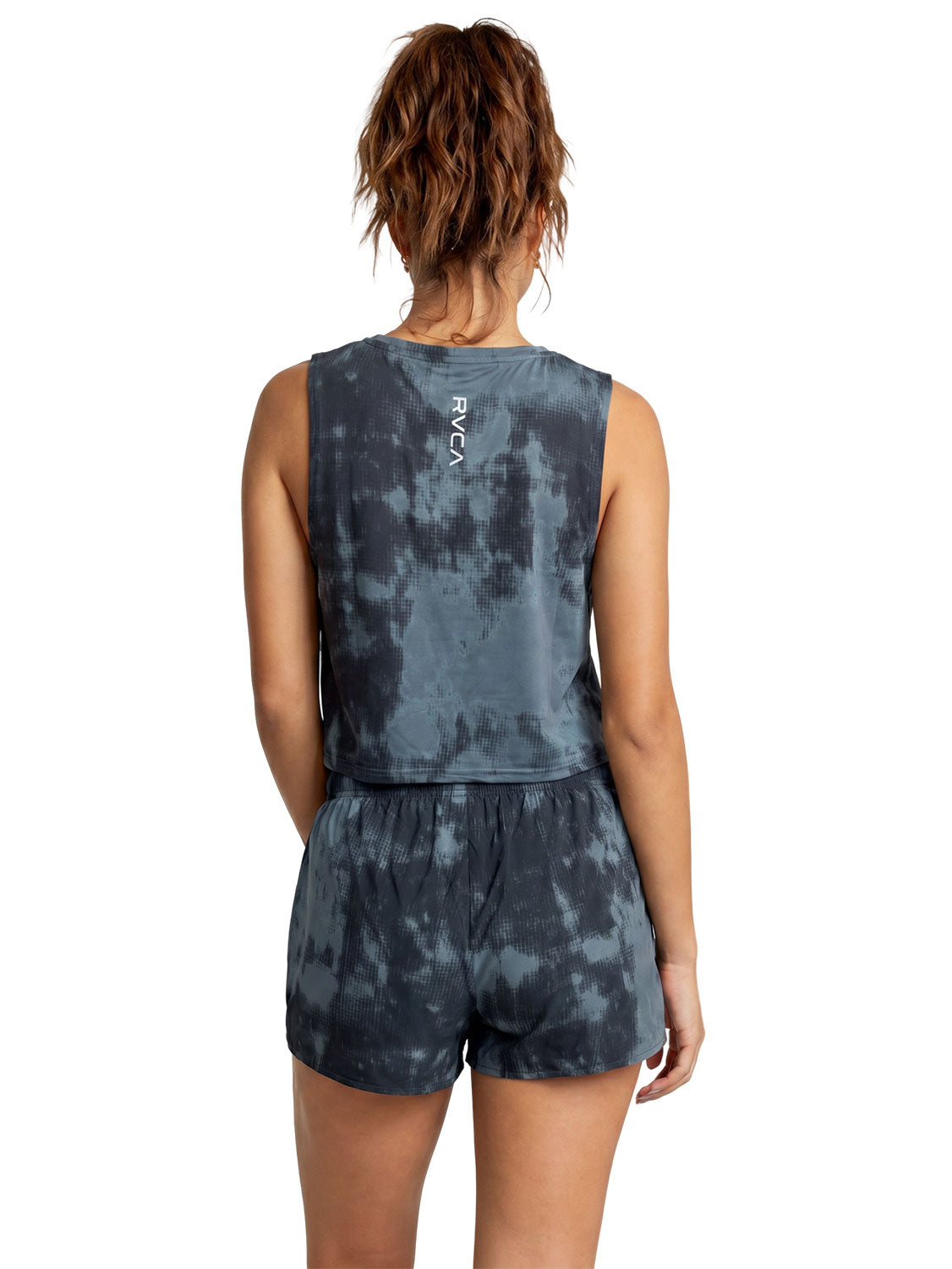Grey and black tie-dye athletic sleeveless crop tank top with veritical RVCA print. Back View