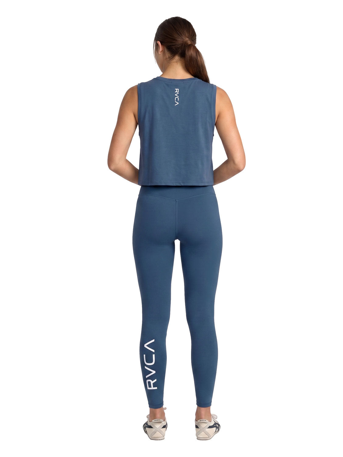 Blue sleeveless athletic crop top with vertical RVCA print. Full Body. Back View