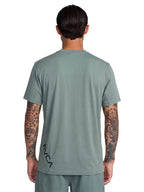Green athletic t-shirt with a black vertical 'RVCA' logo printed on the lower back. Back View