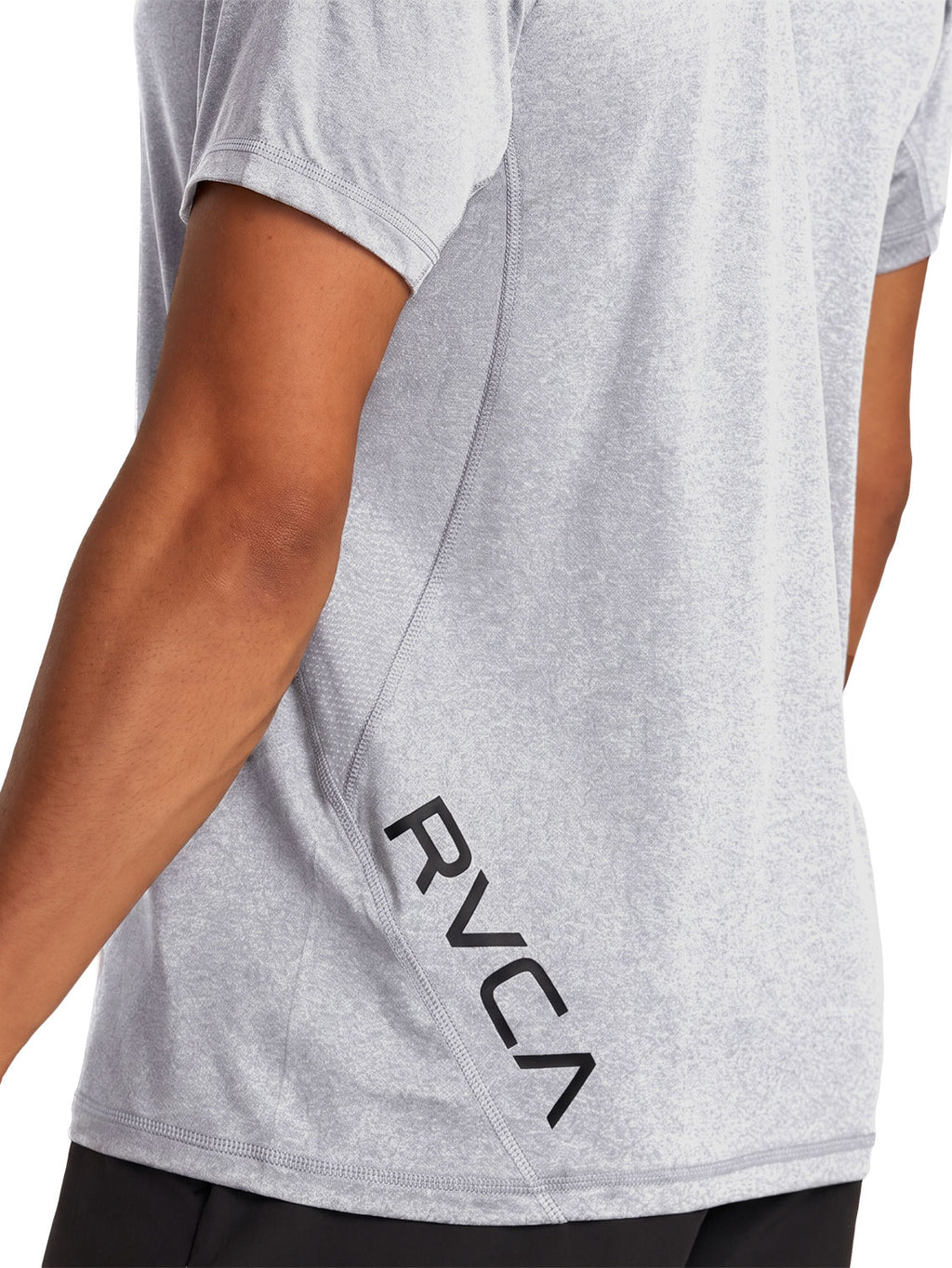 Grey short-sleeve polo shirt with a black RVCA logo printed vertically near the lower left side. Back Close up View