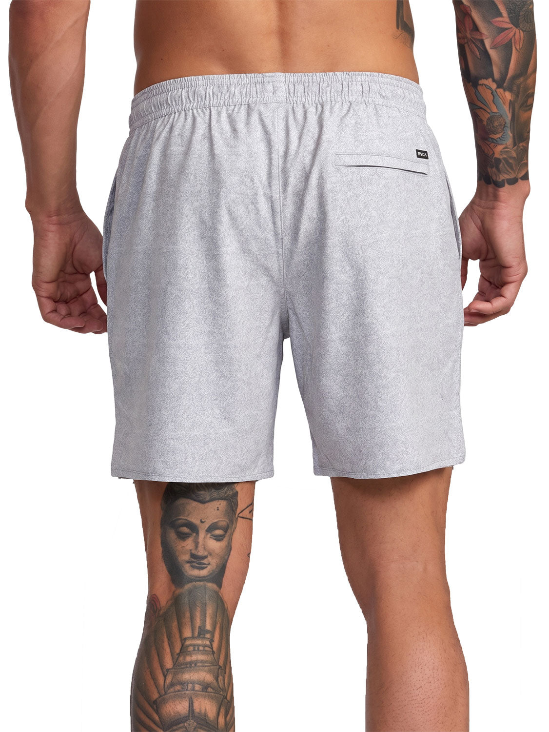 Grey athletic shorts with a small black logo patch on the back pocket. Back View.